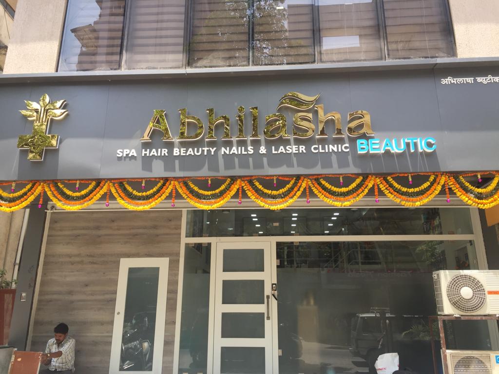 Abhilasha Beautic storefront in Naupada — gold lettering and marigold garlands over the entrance