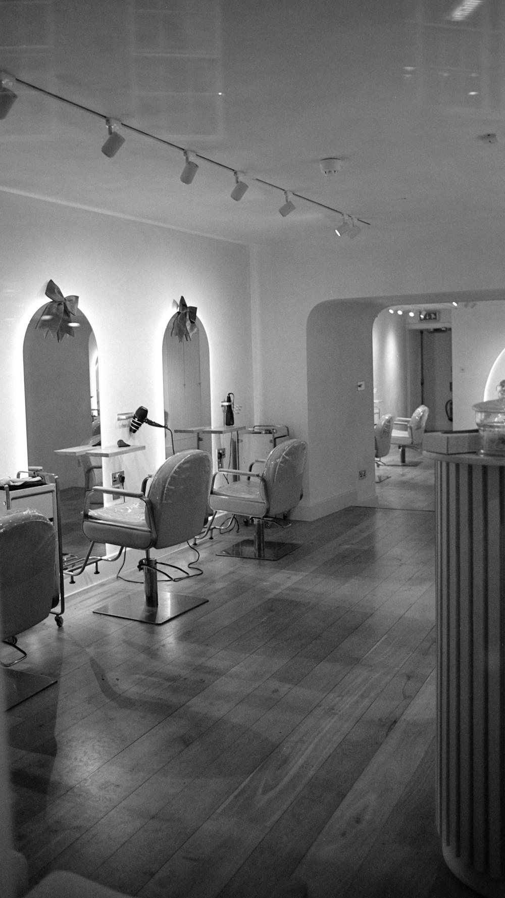 The styling stations and mirrors along the salon wall