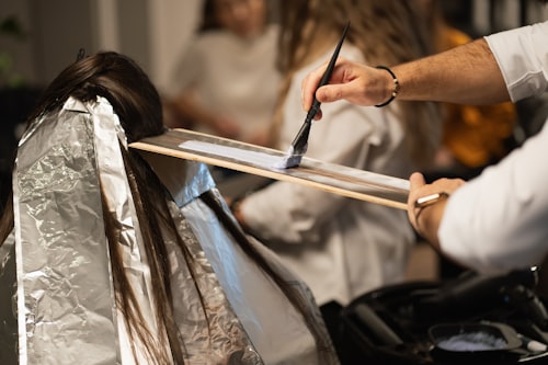Scissors working through a section of a client's hair