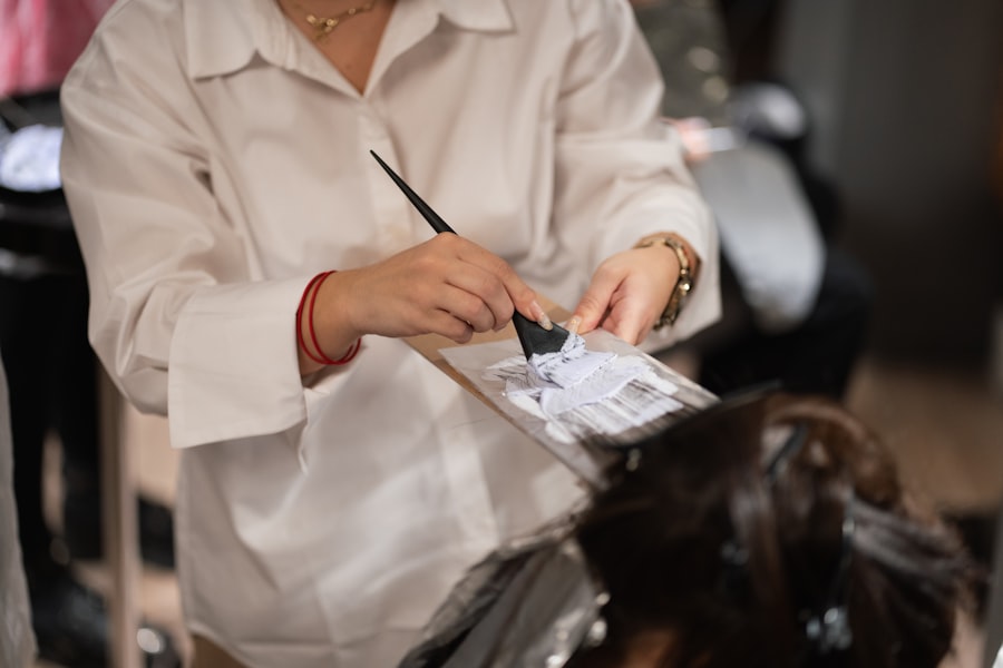 A stylist shaping a client's hair with scissors, mid-cut