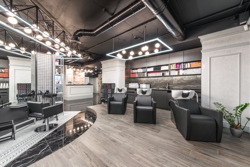 A row of backwash basins and reclining chairs in a quiet salon