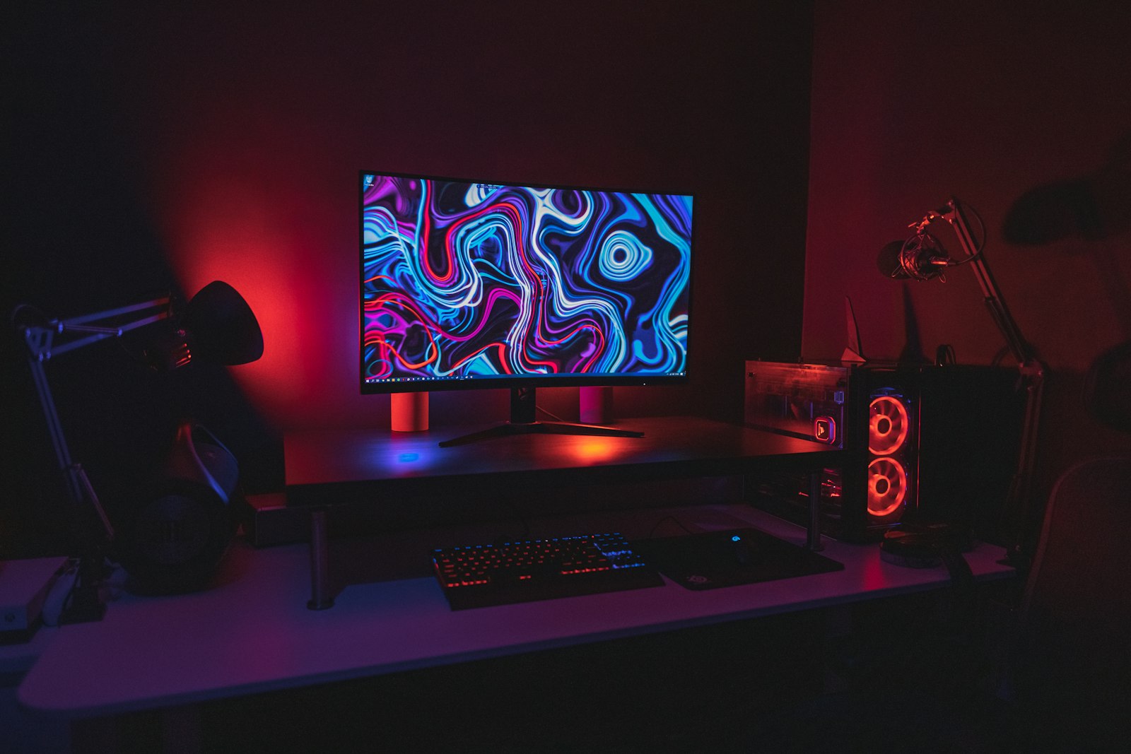 Moody battlestation with a monitor glowing in the dark