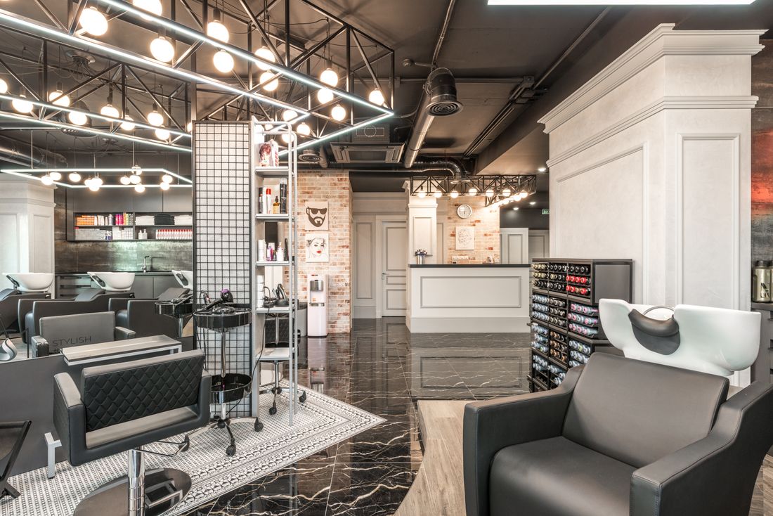 The VIP lounge — styling stations and framed mirrors along the panelled wall