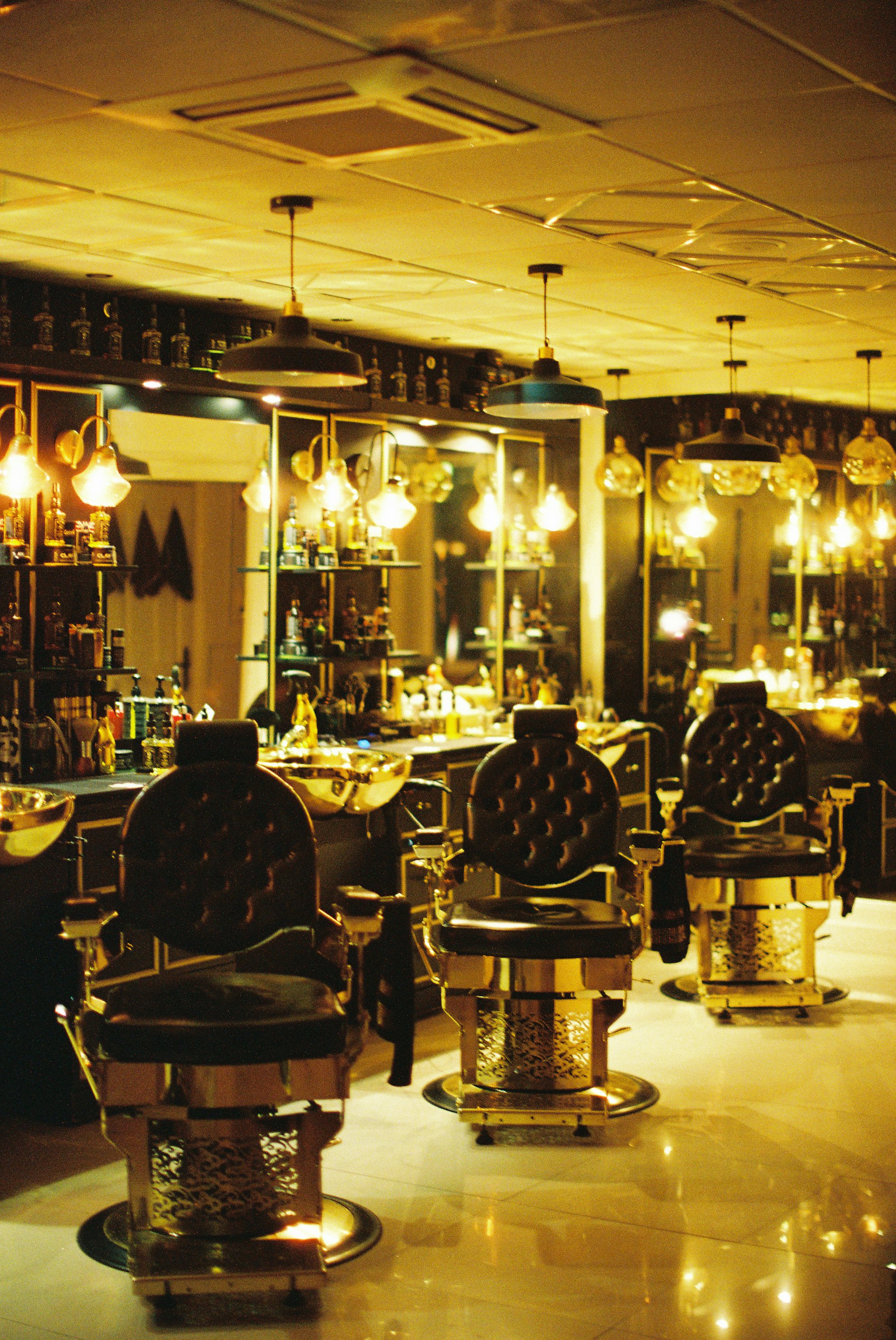 The salon floor at ASTHA Unisex Salon, Shyamal Cross Road, Ahmedabad — chairs and wash basins under warm evening light