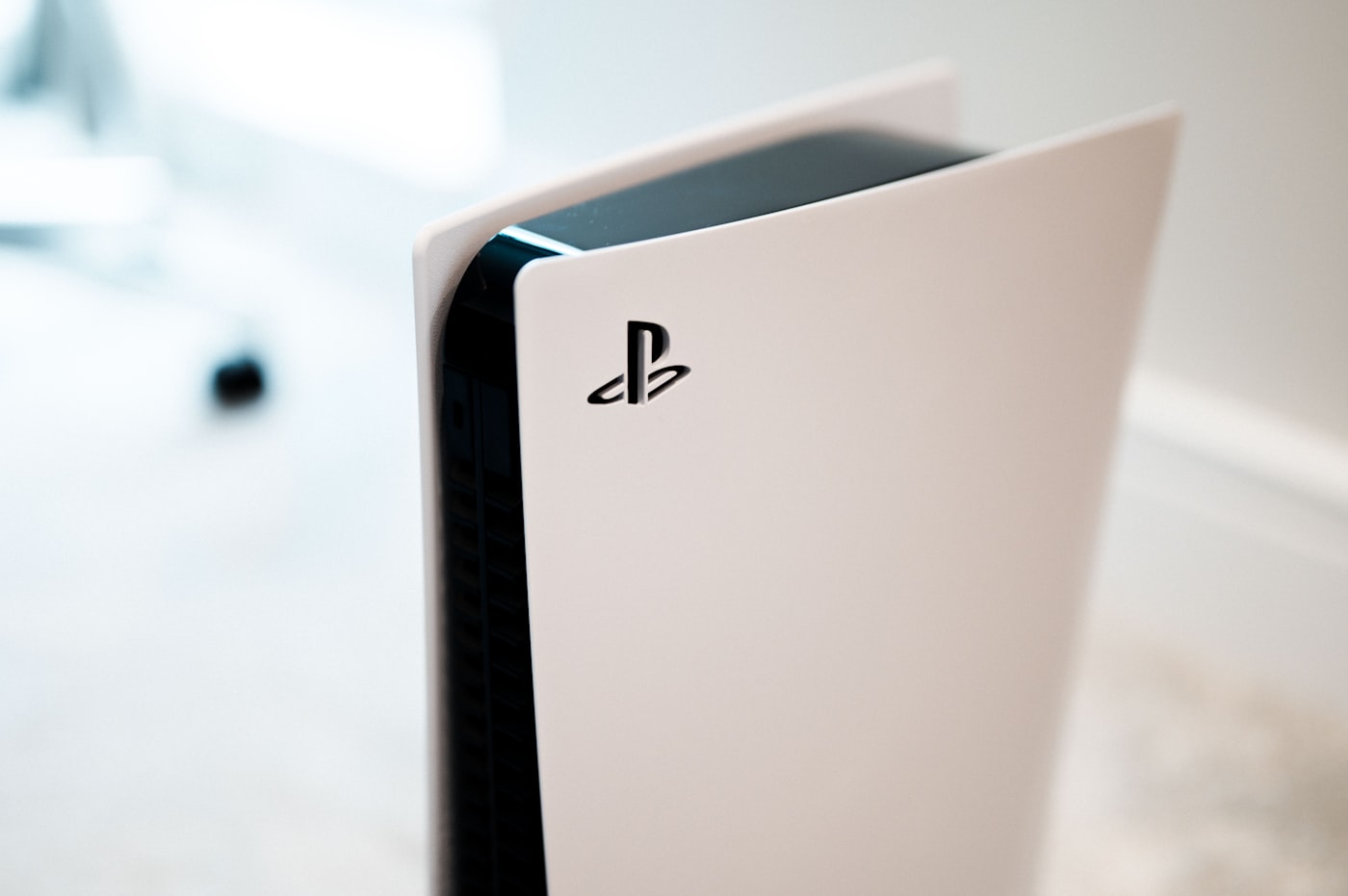 Next-gen gaming console with a wireless controller on a dark desk
