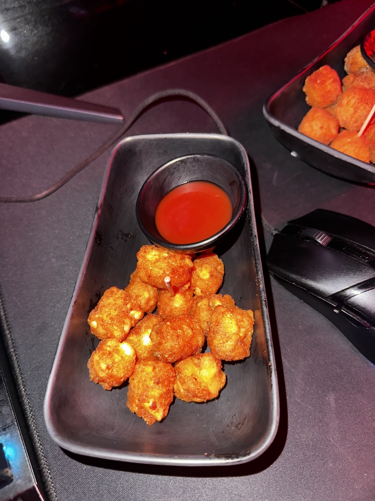 Hot snacks and an energy drink served at a gaming desk