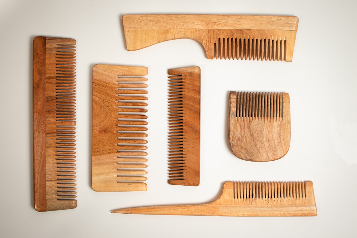 Neem-wood combs laid out on a pale counter