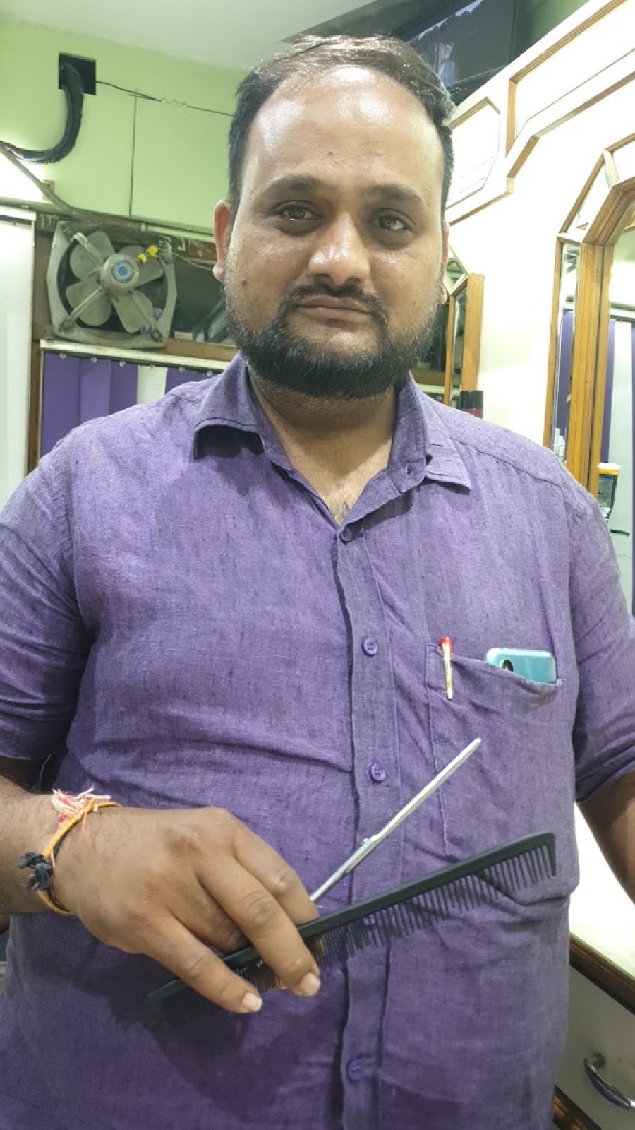 One of the hall's barbers, scissors in hand