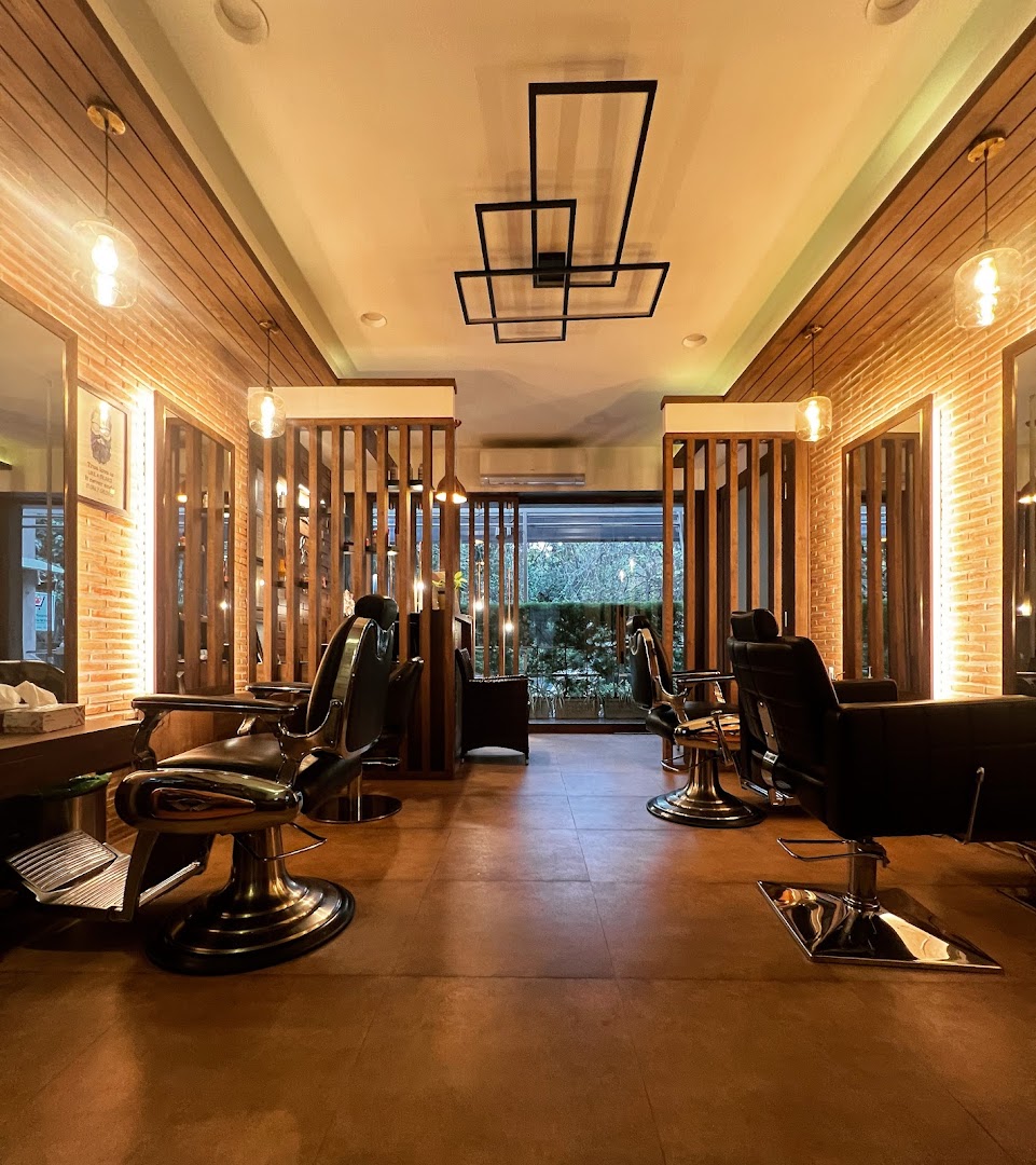 Inside Salon Stories — exposed brick, warm wood slats and the LED ceiling feature over two rows of styling chairs