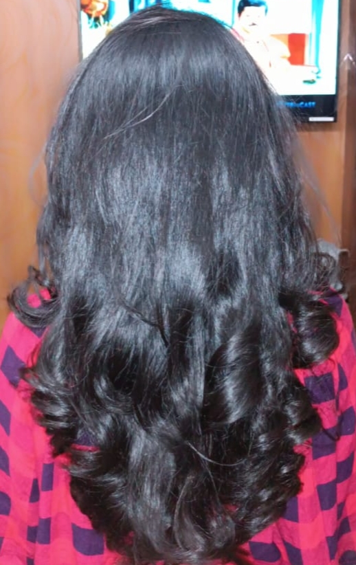 Glossy defined curls over a pink drape at STUDIO@11.