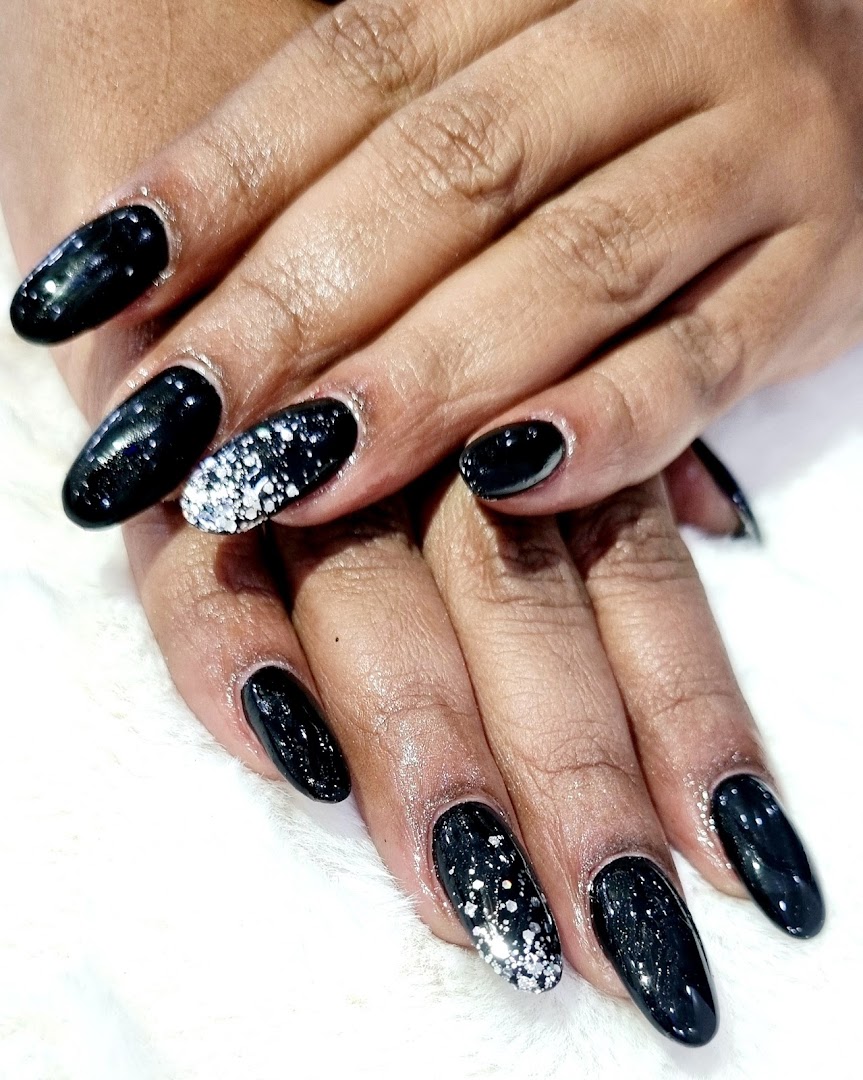 Black almond nails with silver-dust accents from Vibha's nail bar.