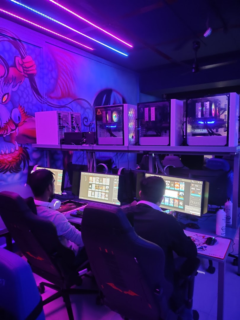 Gamers competing at TGT's neon-lit esports stations