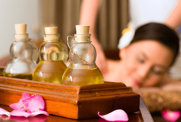 Aromatherapy oils and warm towels laid out before a treatment