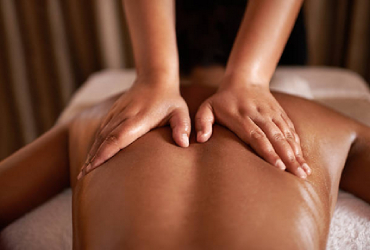Back massage working along the spine and shoulders