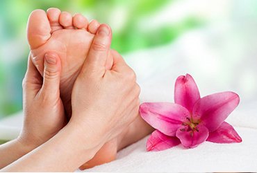 Foot reflexology focusing on pressure points in the sole